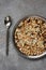 Uncooked multigrain rice in metal plate on wooden background