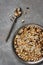 Uncooked multigrain rice in metal plate on wooden background