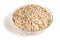 Uncooked oat flakes in glass bowl on white background. Healthy f