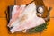 Uncooked ocean red perch fillet, redfish with herbs and spices. Orange background. Top view