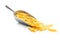 Uncooked penne pasta in scoop. Dried italian pasta