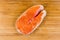 Uncooked piece of arctic char on cutting board, top view