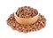 Uncooked pinto beans in wooden bowl on white background