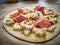 Uncooked pizza with artichokes, champignons, ham and mozzarella on wooden background