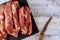 Uncooked pork chops on a wooden board