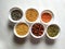 Uncooked pulses,grains and seeds in White bowls over ston background. selective focus