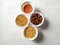 Uncooked pulses,grains and seeds in White bowls over ston background. selective focus