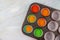 Uncooked rainbow cupcakes on oven tray. Top view