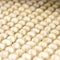 Uncooked raw ravioli or Dumplings. Group of identical objects. Soft focus. Background or texture. Rows of raw dough dish