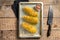 Uncooked raw Tornado or Twist potato fries. Wooden background. Top view