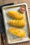 Uncooked raw Tornado or Twist potato fries. Wooden background. Top view