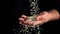 Uncooked rice falls on a man\'s hand. Filmed is slow motion 1000 fps.