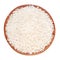 Uncooked rice in a wooden bowl on a white background