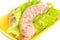 Uncooked Sausage on salad leaf