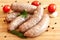 Uncooked sausages with vegetables