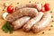 Uncooked sausages with vegetables