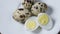 Uncooked scattered quail eggs on white background top view, healthy food concept