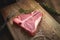 Uncooked t bone steak of beef on the butcher`s Board