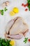 Uncooked thanksgiving or christmas turkey with herbs, lemons garlic