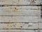 Uncorked white wood slat wall background. Texture of old wall of rusty white wooden panels. Construction and architecture detail