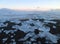Uncountable melting icebergs on the black sand beach under the sunset sky, Iceland