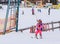 An undefined little skier in the ski lift