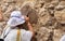 Undefined Orthodox Christian girl pray at Eighth Station of Via Dolorosa. Jerusalem`s Old City.