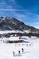 Undefined people skiing and snowboarding in Slopes of Grandvalira ski area of Pyrenees Mountains in Andorra