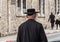 Undefined ultra-orthodox jewish person walk in jewish quarter. Jerusalem