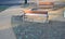 Under the bench are rectangles made of tiles. otherwise, the soft surface of the compacted gravel park path could erode the shoes