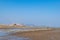 Under the blue sky, the lines and textures of bamboo rafts and ropes in the seaweed farm on the beach are very neat