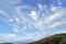 Under the blue sky and white clouds, there is a quiet and beautiful mountain and plateau meadow