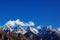 Under the blue sky and white clouds, there are quiet and beautiful snowy peaks