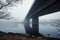 Under the bridge a foggy day