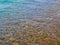 Under the clear sea water visible stones