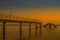 Under construction damaged bridge and pier at Inhaca or Inyaka Island near Portuguese Island in Maputo Mozambique during sunset