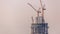 Under construction high-rise building with yellow construction crane in Dubai timelapse