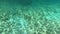 Under ocean water, 4K Underwater scene with volume light abstract video. sandy seafloor and rays of sunlight below water surface.