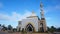 Under the stunning blue sky, an artistic landscape unfolds as we gaze at a luxurious white mosque.