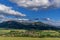 Under the sun and shadows OndÅ™ejnÃ­k and a view of other Beskydy hills and mountains with white clouds and blue sky in the