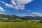 Under the sun and shadows OndÅ™ejnÃ­k and a view of other Beskydy hills and mountains with white clouds and blue sky in the