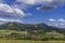 Under the sun and shadows OndÅ™ejnÃ­k and a view of other Beskydy hills and mountains with white clouds and blue sky in the