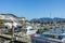 Under a sunny sky in Vancouver, the Coal Harbour Marina captivates with its picturesque view of boats gently swaying in the water