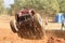 Undercarriage of red car ramping out of steep dugout