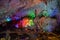 Underground karst cave illuminated by color light