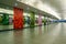 Underground passage between Marina Bay MRT Station and Gardens by the Bay, long empty tunnel with mirrors and floral decorations