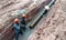 Underground sewerage pipe installed by construction workers at the construction site.