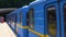 Underground train in blue and yellow arrives at the metro station in Kiev. Ukraine