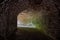 Underground vaulted red brick tunnel under abandoned German fortress. Turn the tunnel