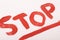 Underlined stop inscription made in red acrylic paint wide strokes art object